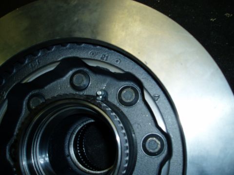 2000 Ford E350 - Close-up view of a vehicle's wheel hub and brake rotor assembly, showing internal splines and bolt holes.