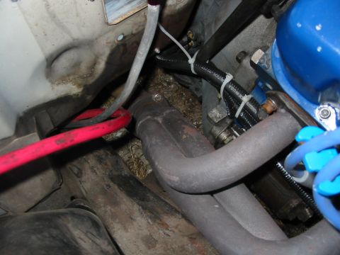 1985 Ford Crown Victoria LTD - Close-up view of engine bay components, including exhaust manifold and wiring, with a Supermotors.net watermark.
