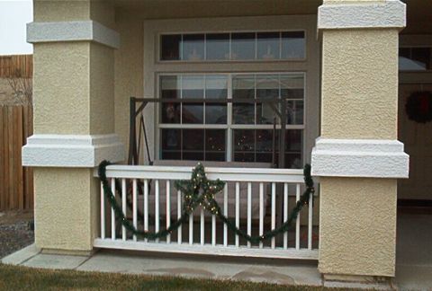 1986 Ford Bronco - Front porch decorated for Christmas with garland and a star on the railing.