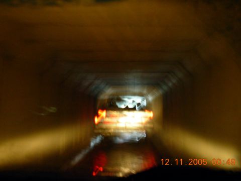 1987 Ford Bronco - A blurry view of vehicles traveling through a tunnel with lights visible.