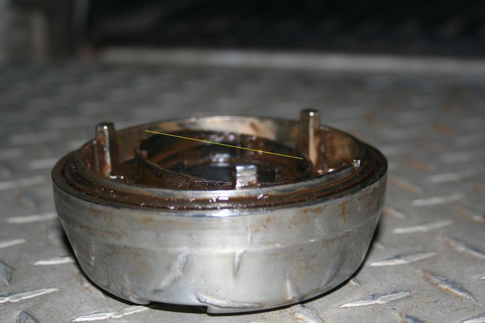 Broken Ford manual hub. Wont allow the internal piece to engage, as it applies pressure to only one side of it.
The yellow line shows how the pressure plate is only receiving tension from one spring. I rebent the other spring and now just leave the hubs locked 24/7.