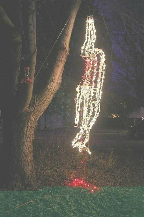 2005 Dodge 1500 - Outdoor Halloween decoration features a hanging light-up figure illuminated at night.