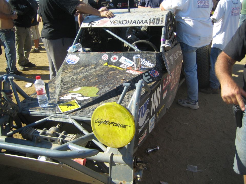 Front of a tube-chassis off-road buggy with Yokohama-branded sun visor, number 1401, and yellow Lightforce light cover