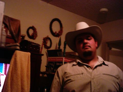 1986 Ford Bronco - A man in a cowboy hat poses for a photo indoors, with a television screen visible to the left.