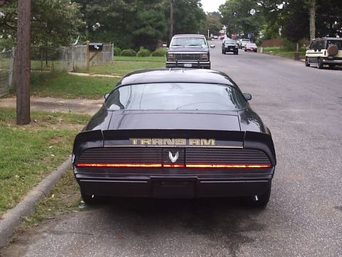 1979 Pontiac Trans Am - Rear view of a black 1979 Pontiac Trans Am, showing the distinctive taillight bar and gold 'TRANS AM' badging.