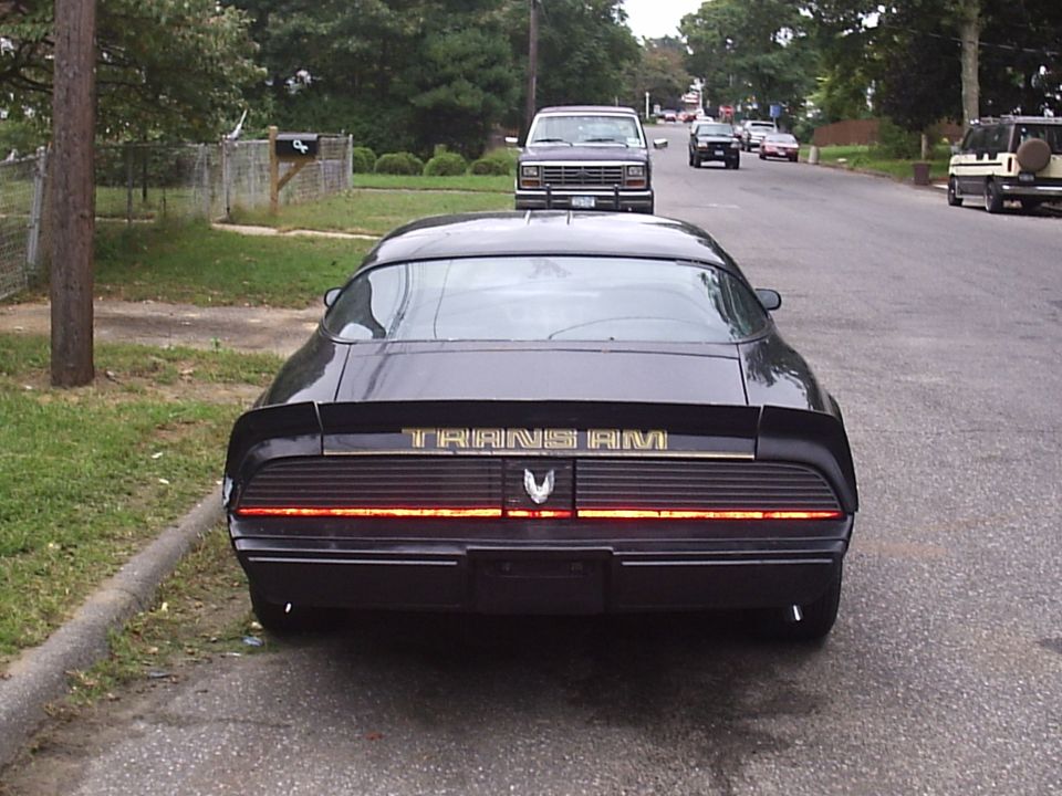 Black 1979 Pontiac Trans Am rear view with gold lettering