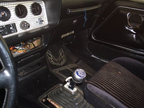 1979 Pontiac Trans Am - Interior view of a 1979 Pontiac Trans Am, the iconic bird floor mats and a chrome shifter knob.