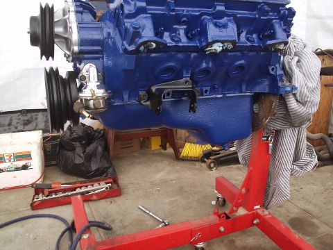 1979 Pontiac Trans Am - A blue engine is mounted on a red stand, ready for installation or repair.
