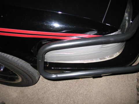 2000 Ford Crown Victoria - Front corner of a black car with a bull bar and red racing stripes.
