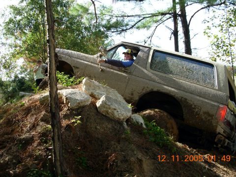 1987 Ford Bronco - This 1987 Ford Bronco is shown off-roading on a challenging, muddy, and rocky course.