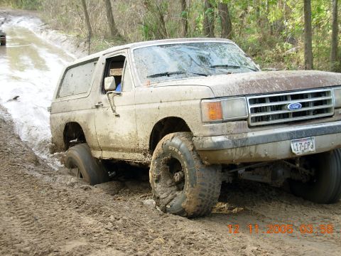 1987 Ford Bronco - This 1987 Ford Bronco is stuck deep in the mud on an off-road trail.