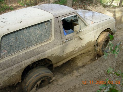 1987 Ford Bronco - This 1987 Ford Bronco is deeply stuck in thick mud on a wooded trail.
