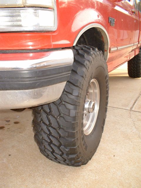 1995 Ford F-150 - Close-up of a 1995 Ford F-150's front wheel and fender, fitted with aggressive off-road tires.
