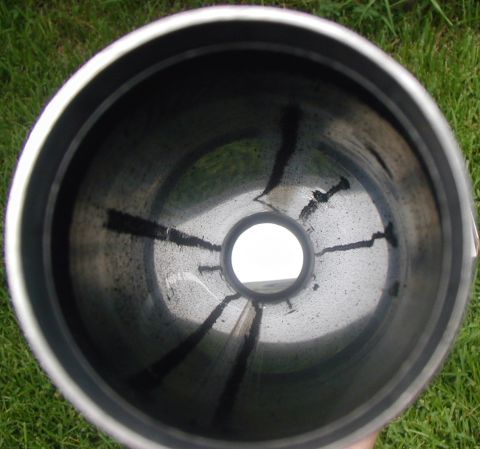 2000 Ford Crown Victoria - The interior of an exhaust pipe shows significant carbon deposits and soot.