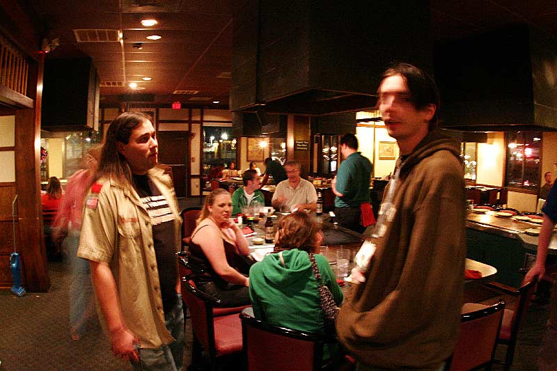 People gathered around tables inside a restaurant