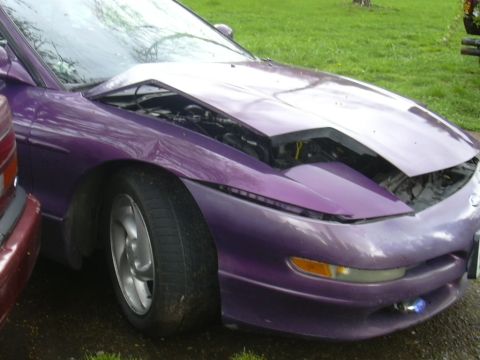 1997 Ford Probe - Front view of a purple 1997 Ford Probe with its hood open, revealing the engine compartment.
