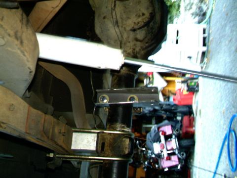 1987 Ford Bronco II - Close-up of a rear axle shock mount and U-bolt assembly, likely during installation or repair.