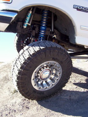 1995 Ford Bronco - This 1995 Ford Bronco features a lifted suspension with prominent shocks and large off-road tires.
