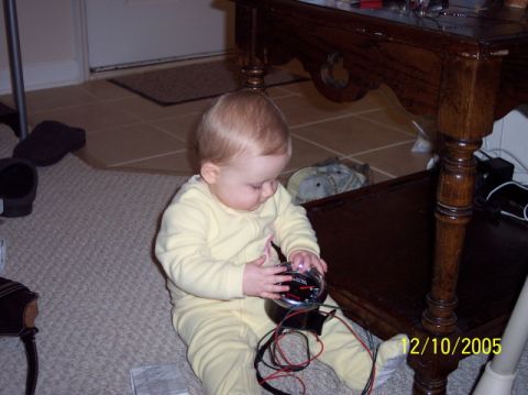 1979 Ford Bronco - A baby plays with a car gauge on the floor, wires trailing.