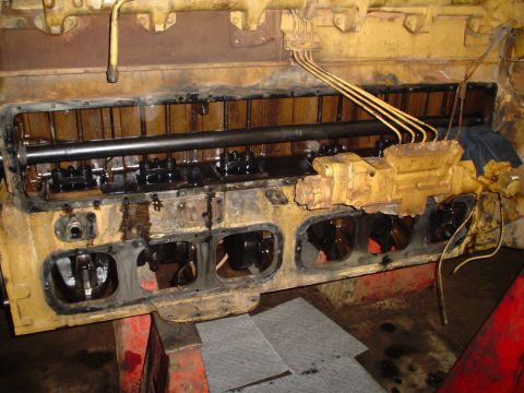 1966 International School Bus - Close-up view of a yellow engine block, showing internal components and fuel lines.