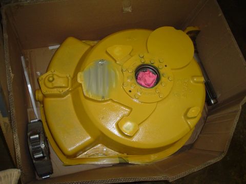 1966 International School Bus - Unidentified yellow engine part, possibly a transmission or clutch housing, in a box.