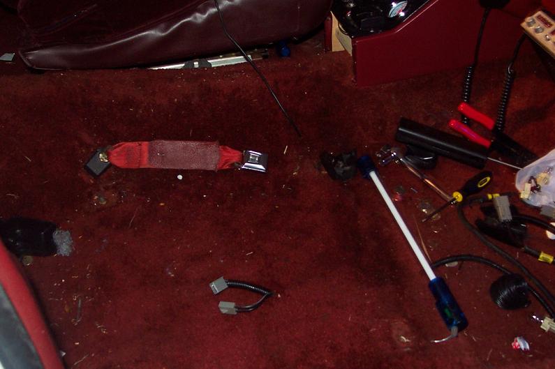 Red seatbelt and carpet inside a vehicle interior
