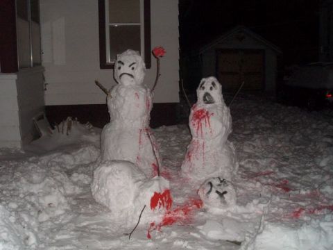1996 Ford Probe - Snowmen decorated with fake blood create a spooky winter scene outside a house at night.