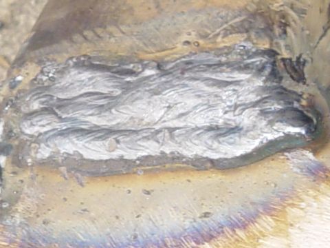 1989 Ford Bronco - This image shows a close-up view of a metal weld seam, likely from a vehicle part, with visible discoloration.