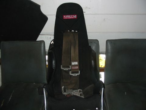 1985 Ford Crown Victoria LTD - A racing seat with a Kirksey logo and harness is shown, flanked by other seats.
