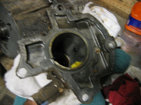 1992 Ford Bronco - Close-up of a dirty cast aluminum housing, likely a transmission or transfer case component, showing a large round bore opening with intern…