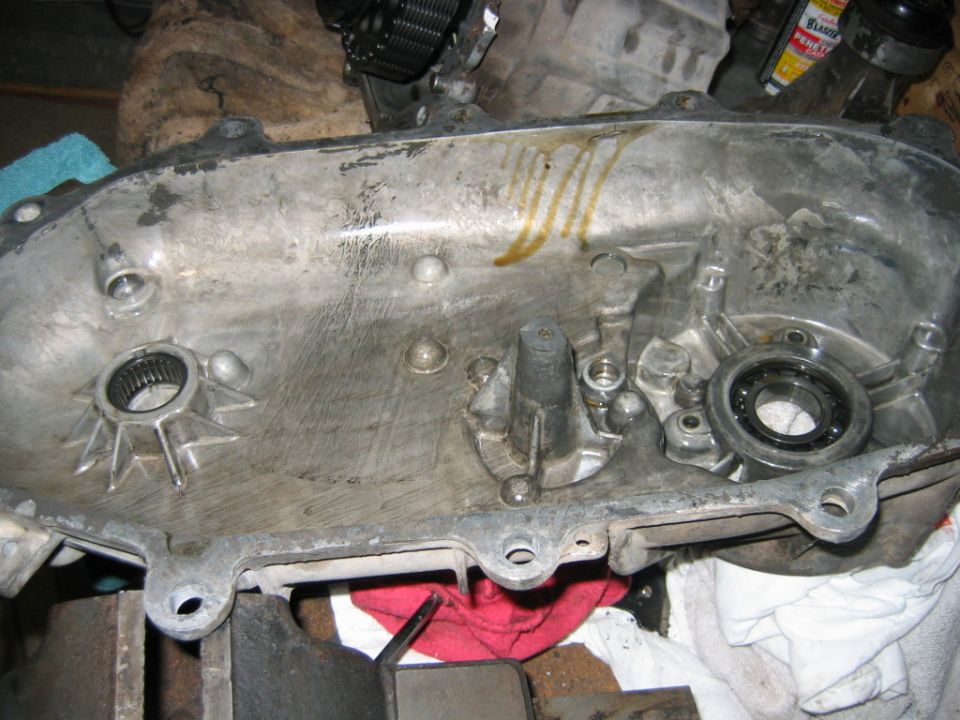 Aluminum gearcase cover interior with splined hub and bearing on a workbench