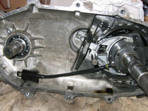 1992 Ford Bronco - Interior of an opened aluminum transfer case or transmission housing showing internal gears, bearings, a splined output shaft, and a planet…
