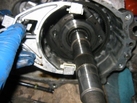 1992 Ford Bronco - Close-up of a disassembled manual transmission showing the input/output shaft with splined tip, internal ring gear and synchronizer compone…