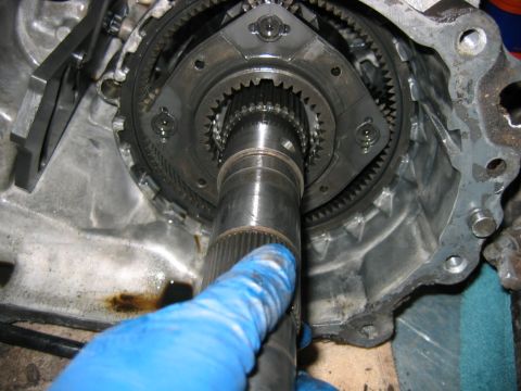 1992 Ford Bronco - Close-up of a disassembled manual transmission showing the input shaft splines, synchronizer hub and ring gear inside the aluminum bellhous…