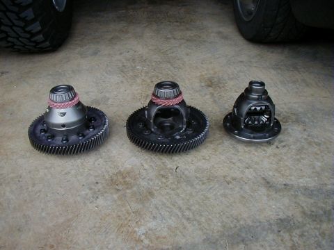 1995 Ford Probe - Three differential gears are laid out on a concrete surface, with a vehicle tire visible in the background.