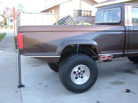1985 Ford Ranger - Rear view of a 1985 Ford Ranger pickup truck, equipped with a Hi-Lift jack and a spare tire.