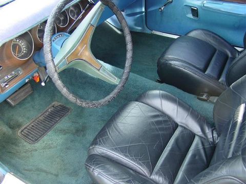 1993 Ford Bronco - Interior view shows black leather seats and teal carpeting, with a Dodge steering wheel.