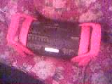 1986 Ford Bronco - A car stereo is secured with pink straps against a floral background.