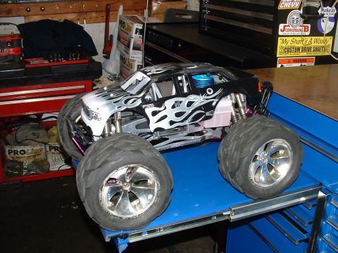 1994 Ford Bronco - This remote control monster truck features a flame graphic on its body and chrome rims on its large tires.