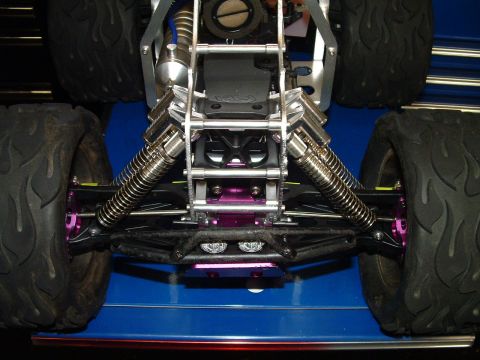 1994 Ford Bronco - Close-up view of the front suspension and large tires on a remote control monster truck.