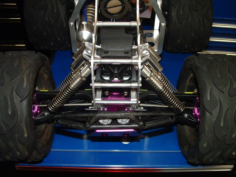 Remote control monster truck front suspension with purple shocks and large tires