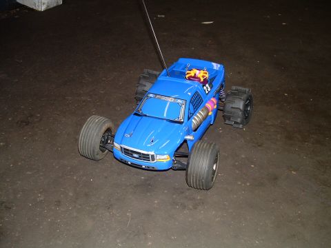 1994 Ford Bronco - Blue remote control monster truck with F-350 markings sits on a dark surface.