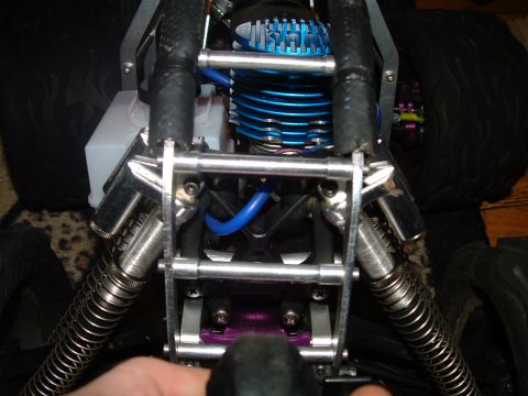 1994 Ford Bronco - The engine of a remote control car is visible, with blue tubing and metal components.
