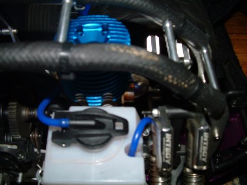 1994 Ford Bronco - Close-up view of a blue engine and fuel system components on a remote control car.