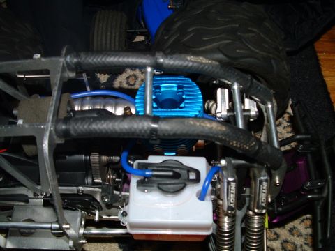 1994 Ford Bronco - RC car engine detail with blue cooling fins and a white fuel tank.