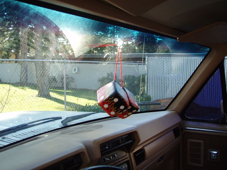 after i got the truck home, i noticed the rearview mirror is GONE... i looked everywhere in the truck..and no mirror. So, i imprevised to hang up my dice and used a little suction cupped  hanger thingy my mom used on the Xmas Decorations.