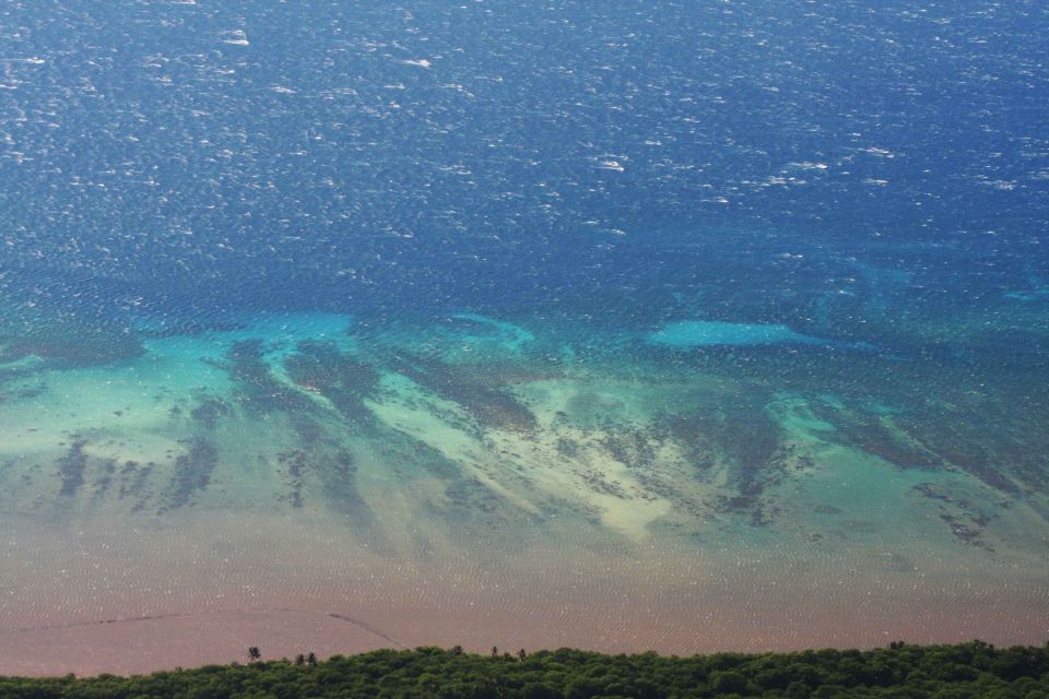 Aerial view of ocean and coastline with Supermotors logo