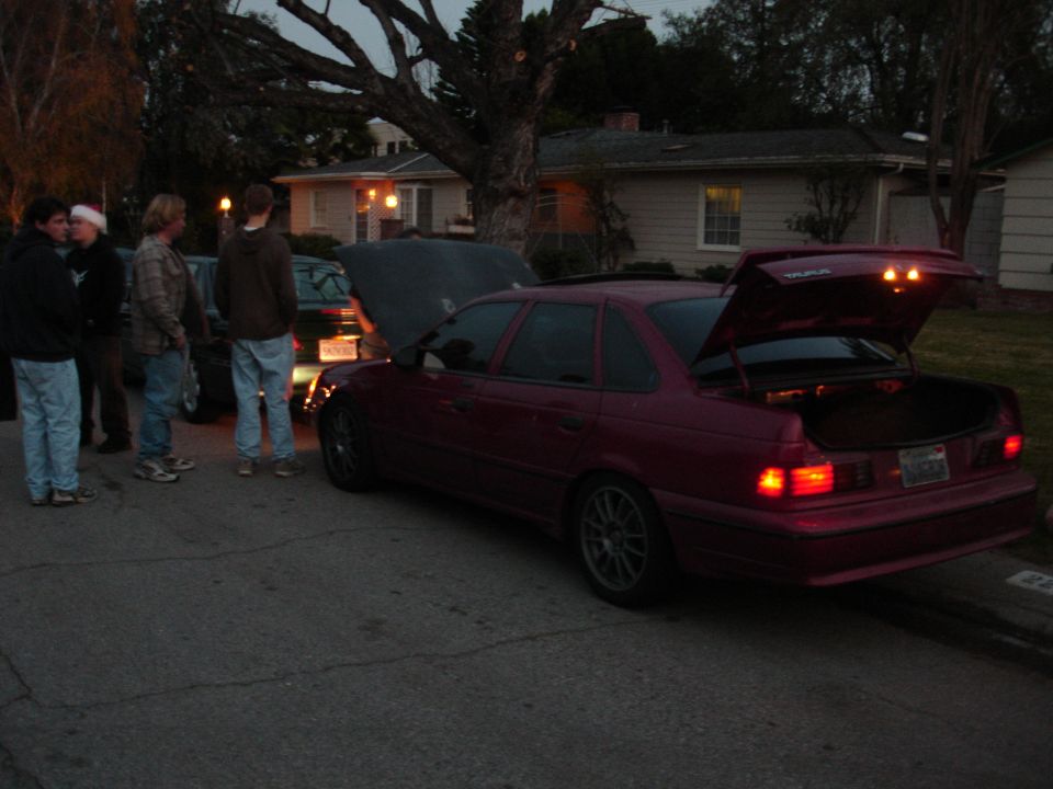 Maroon 1995 Ford Taurus sedan, rear view, trunk and hood open