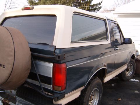 1993 Ford Bronco - This 1993 Ford Bronco is seen from the rear, a two-tone paint scheme and a spare tire mounted on the tailgate.