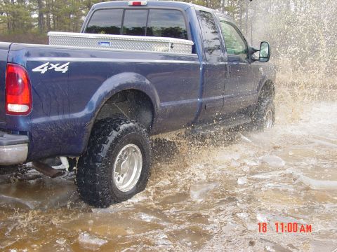 1995 Dodge 1500 - Pickup truck splashes through water and ice, kicking up spray.